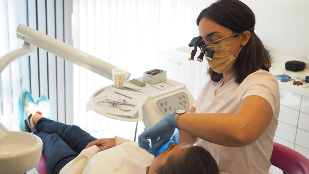 endodontist is treating her patient in Istanbul dental clinic Dent Design.